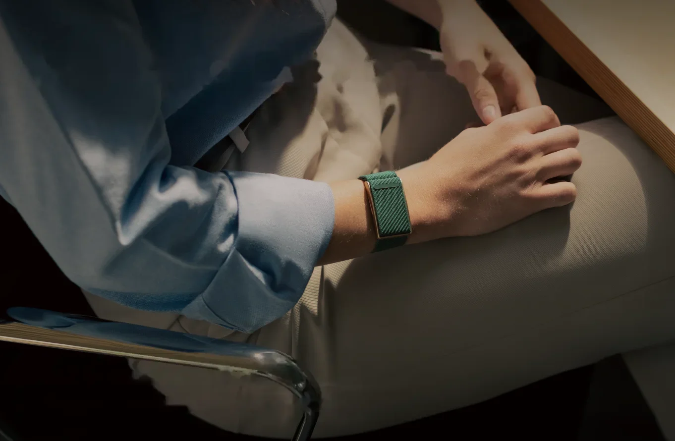 Person wearing a green Speediance Strap while resting a hand on their knee