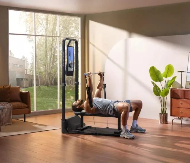 Bench press on the Gym Monster 2 in a sunlit living room